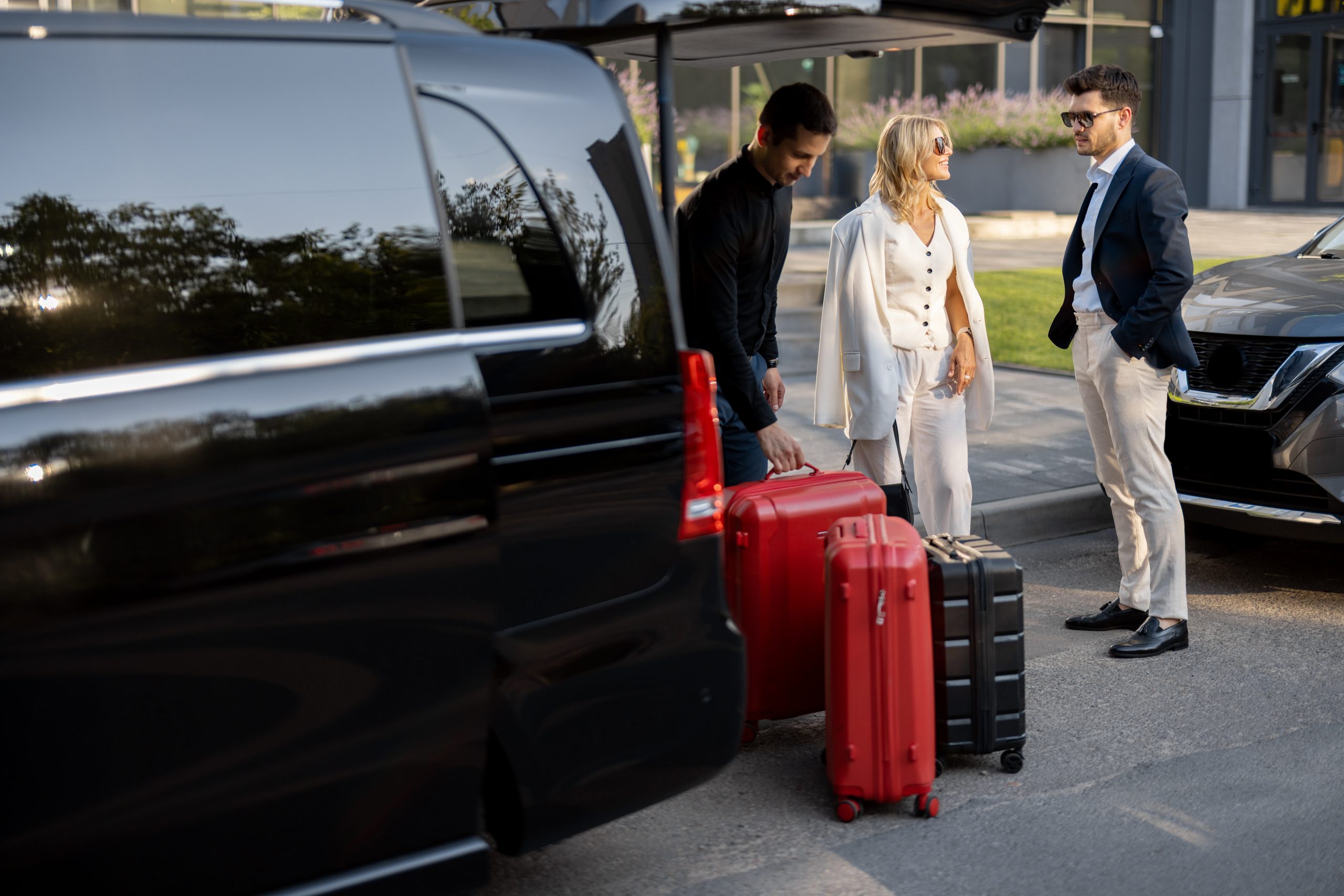 couple with a suitcase in a minivan taxi